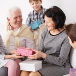 Grandchildren giving presents to grandparents